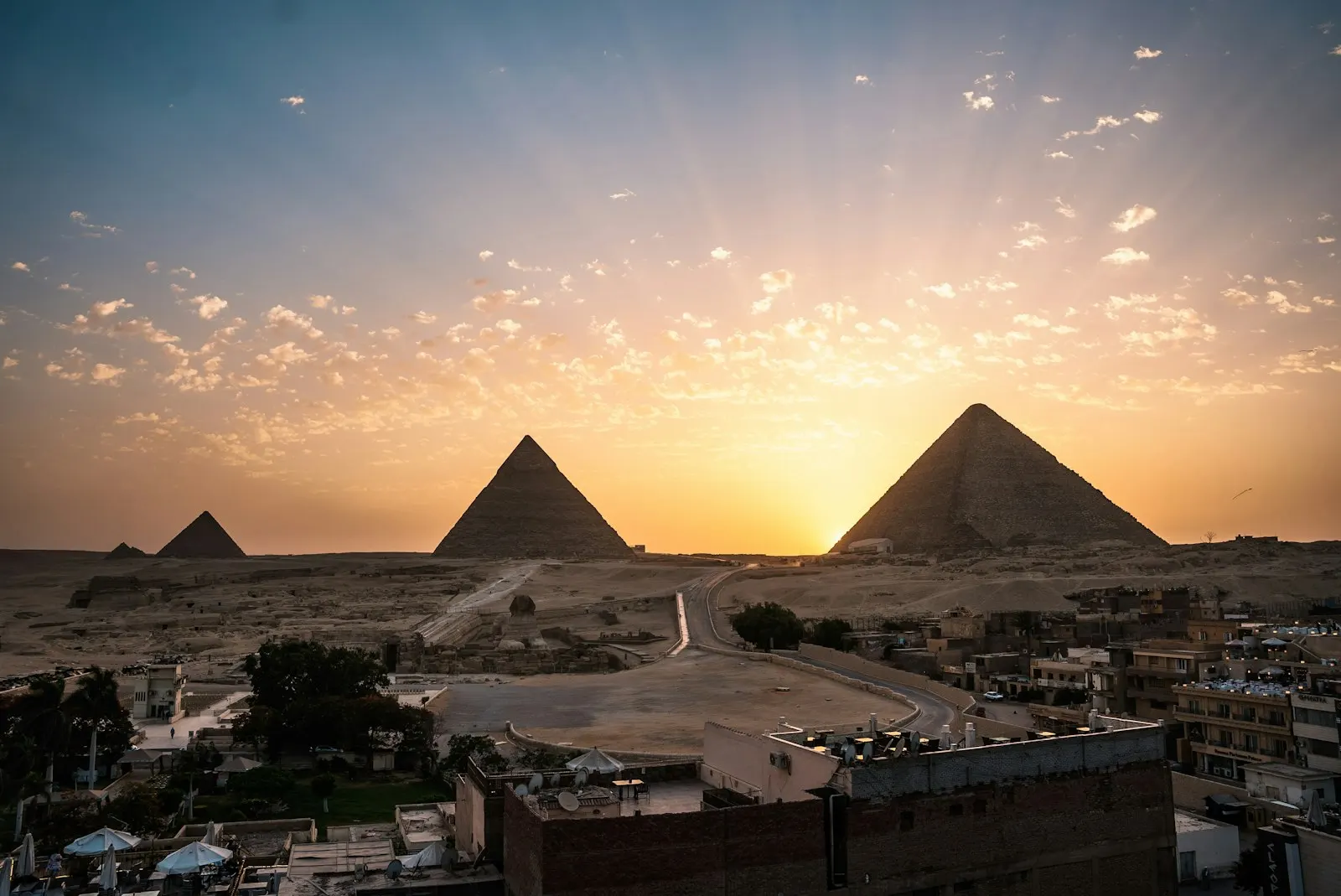 White and brown houses under blue sky during daytime The pyramids at Gizeh, Egypt: Egypt holiday packages by OYG Holidays