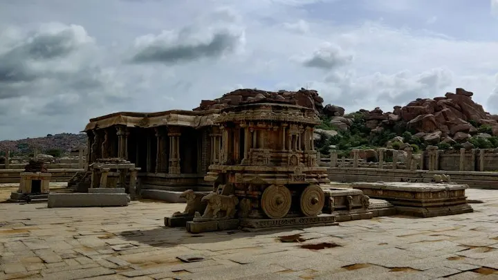 A building with a large stone structure in the front: Hampi holiday packages by OYG Holidays