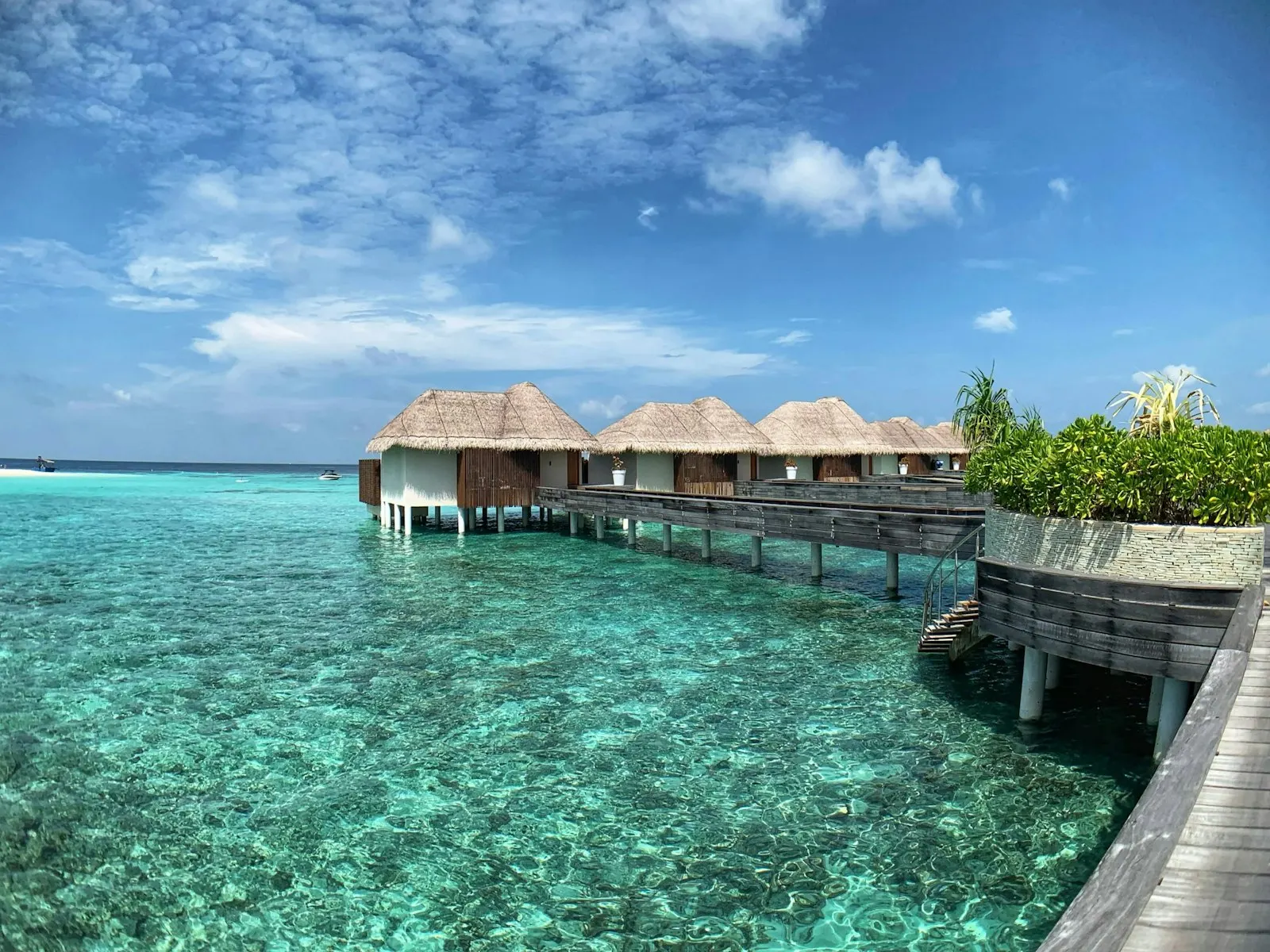 Brown wooden house on body of water under blue sky during daytime Overwater Villa at the W Hotel luxury resort in the Maldives: Maldives holiday packages by OYG
